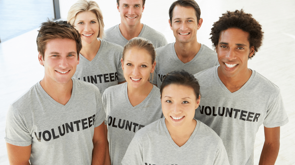Image shows individuals wearing 'Volunteer' shirts, representing tCaPc